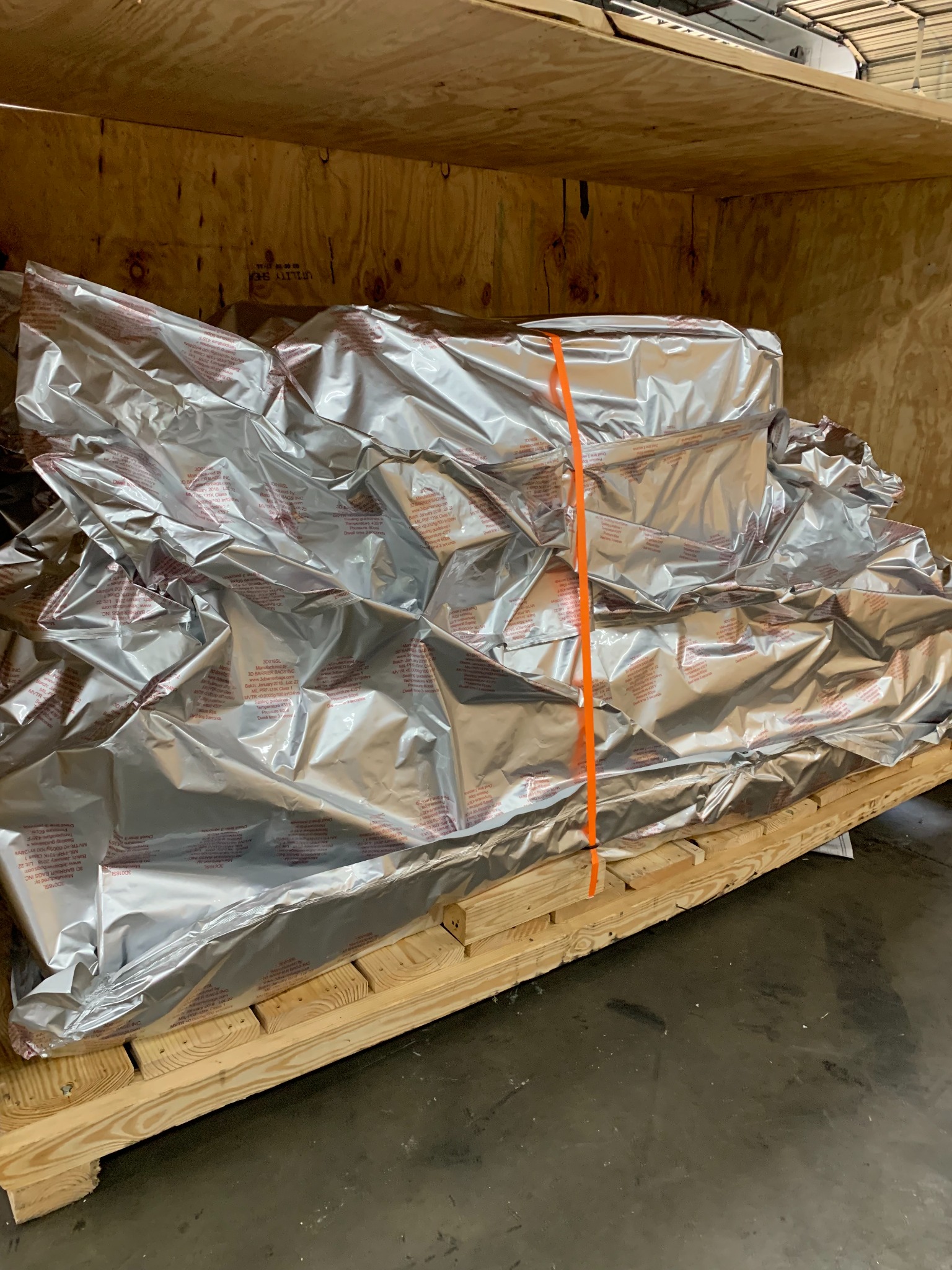 Foil-wrapped machinery secured to a pallet