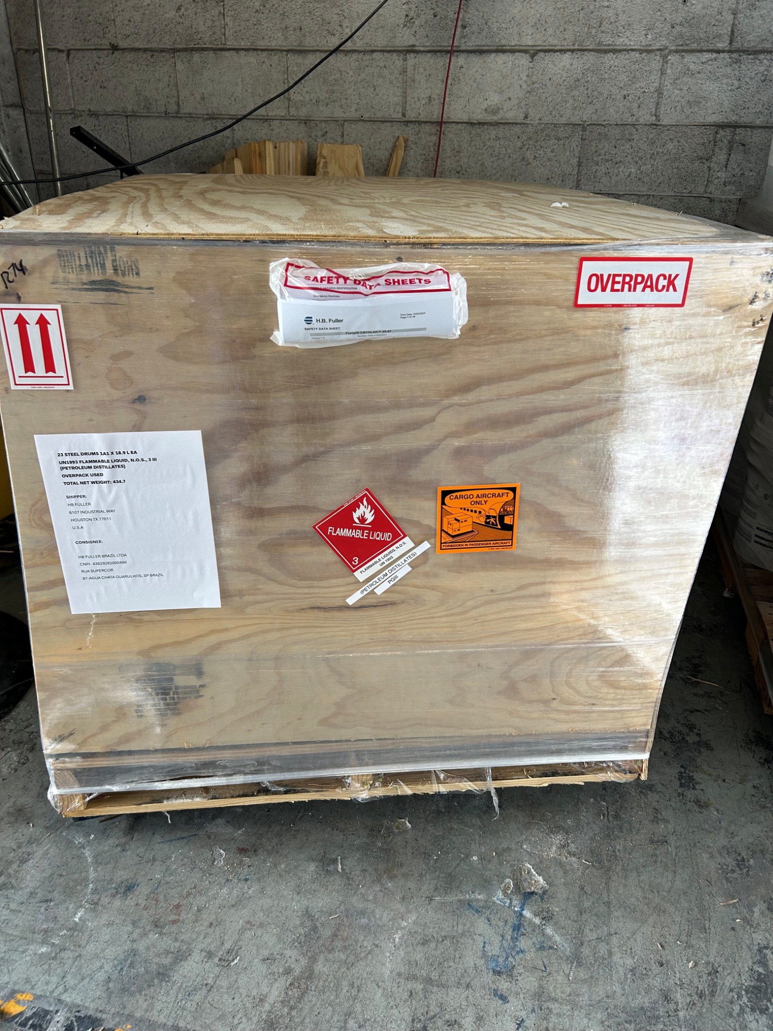 Dangerous goods export crate with hazard labels and overpack marks