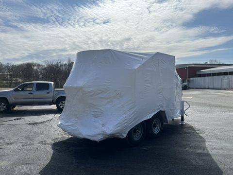 Large trailer fully protected in white heat-shrink film