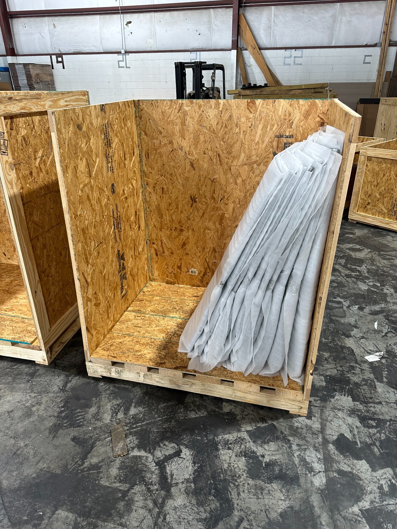 Long wooden crate with protected components inside