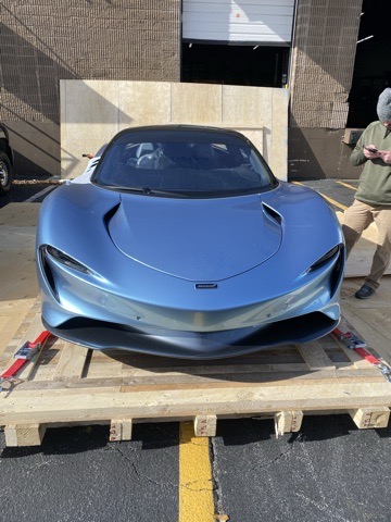 Silver McLaren positioned for specialist vehicle shipping
